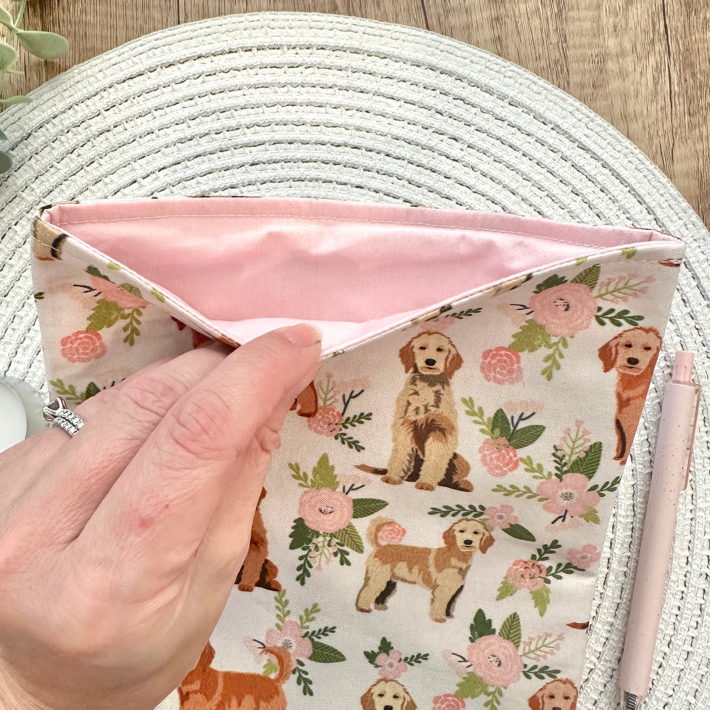 interior soft pink lining of dog-themed book pouch
