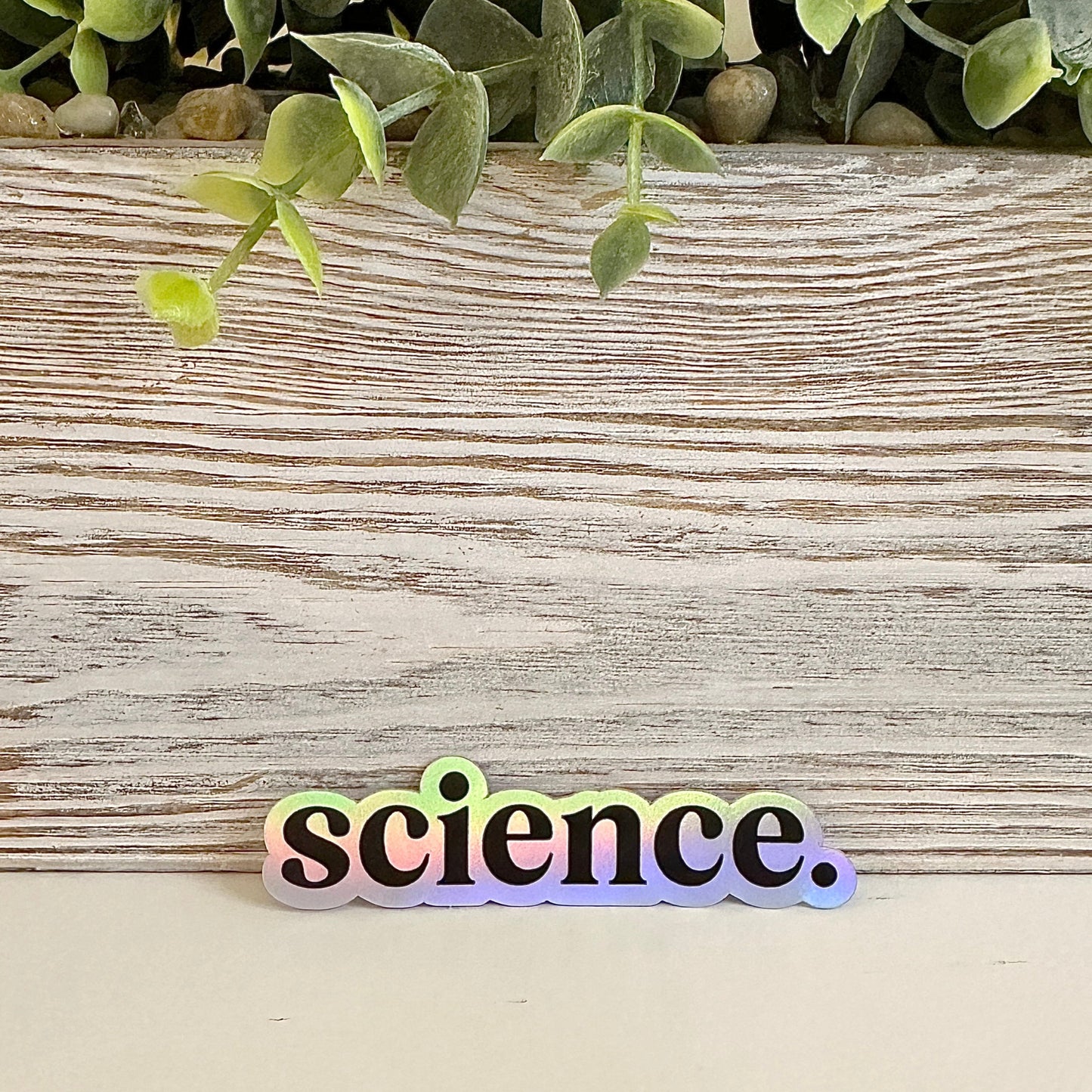 Holographic 'science.' sticker on a table