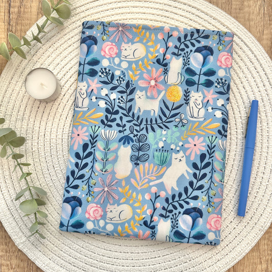 cats and flowers-patterned fabric book sleeve