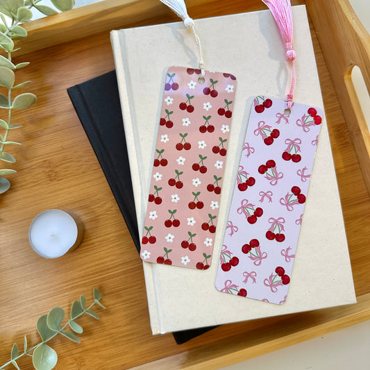 Two cherry-themed bookmarks on a book
