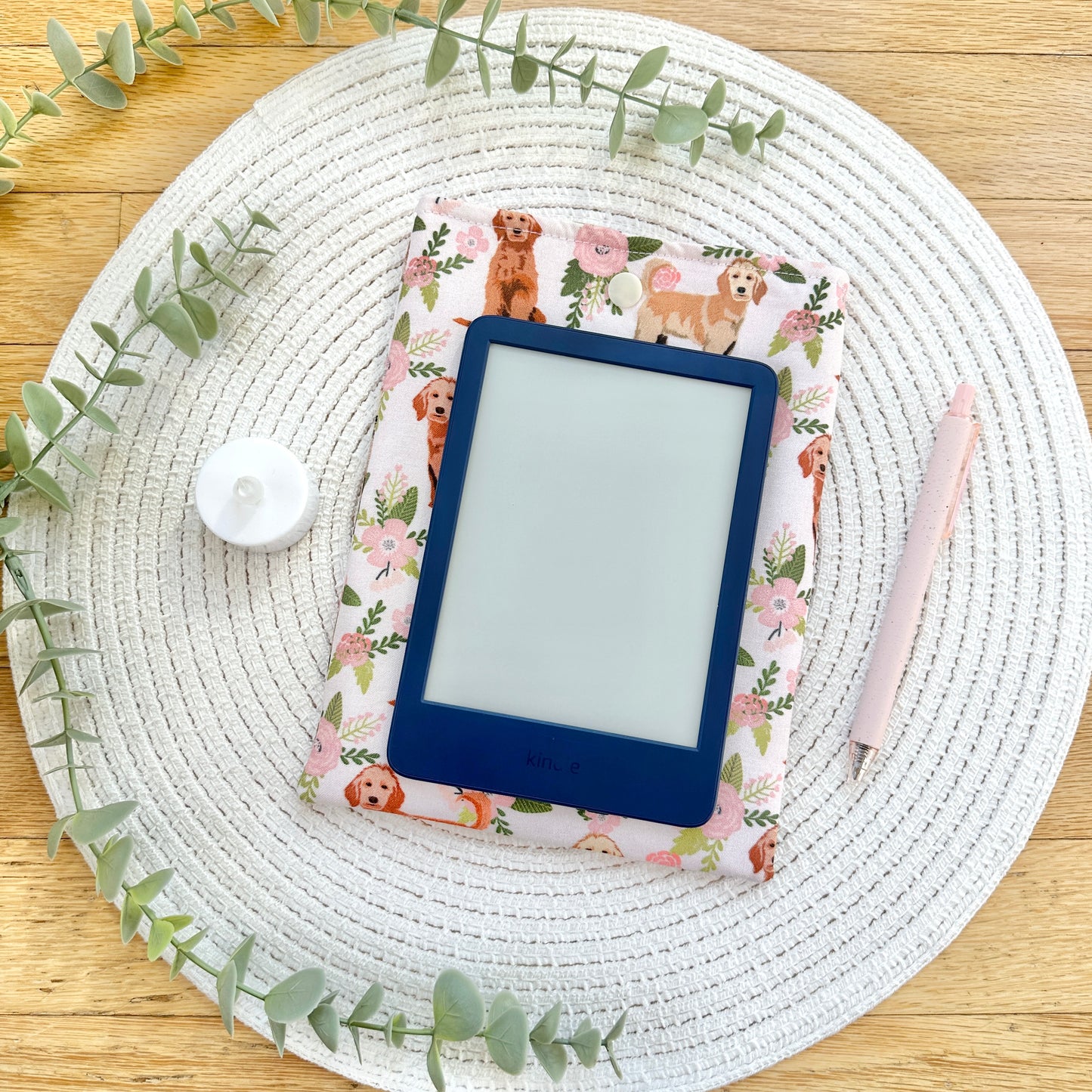 e-reader laying on dog-themed e-reader sleeve 