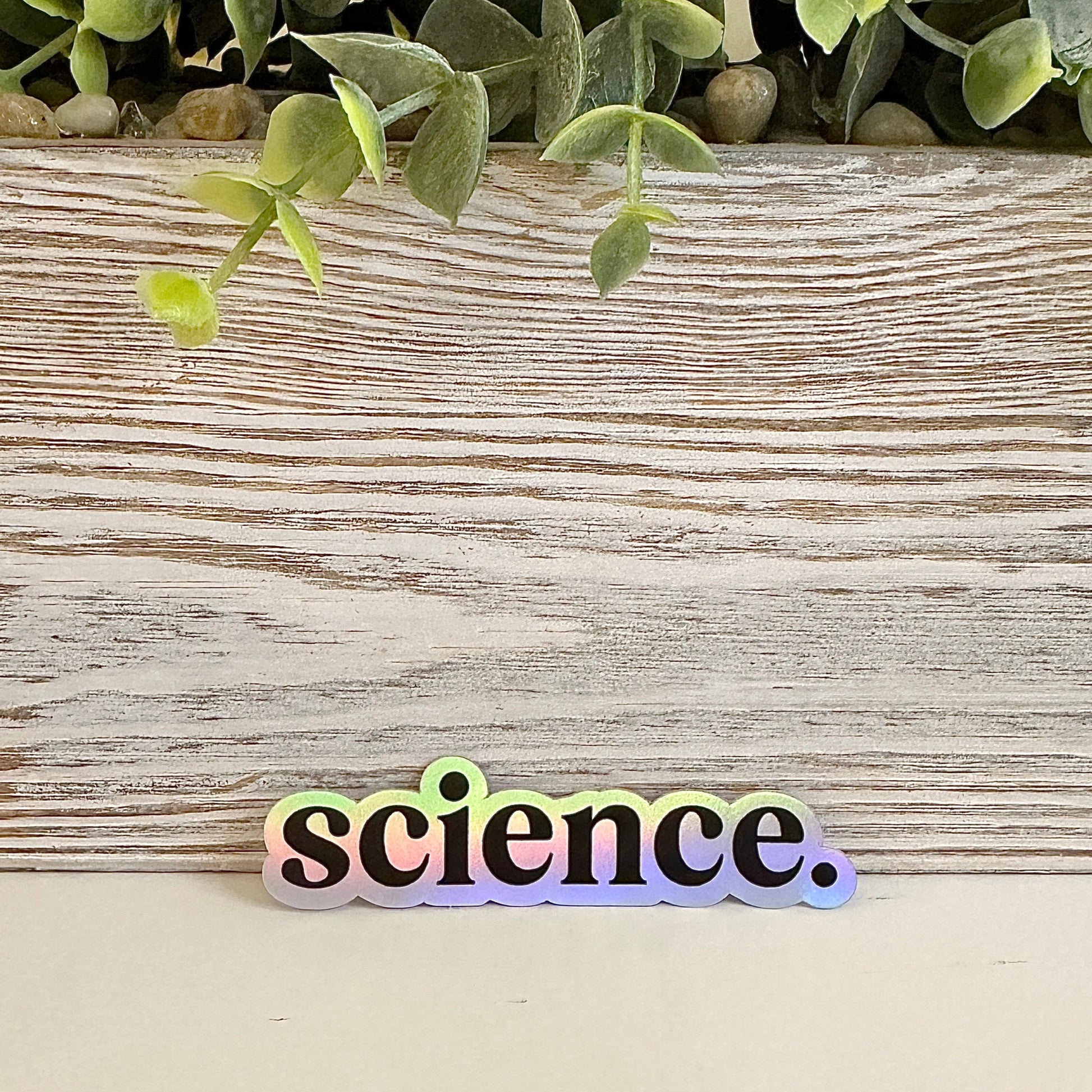 Holographic 'science.' sticker on a table