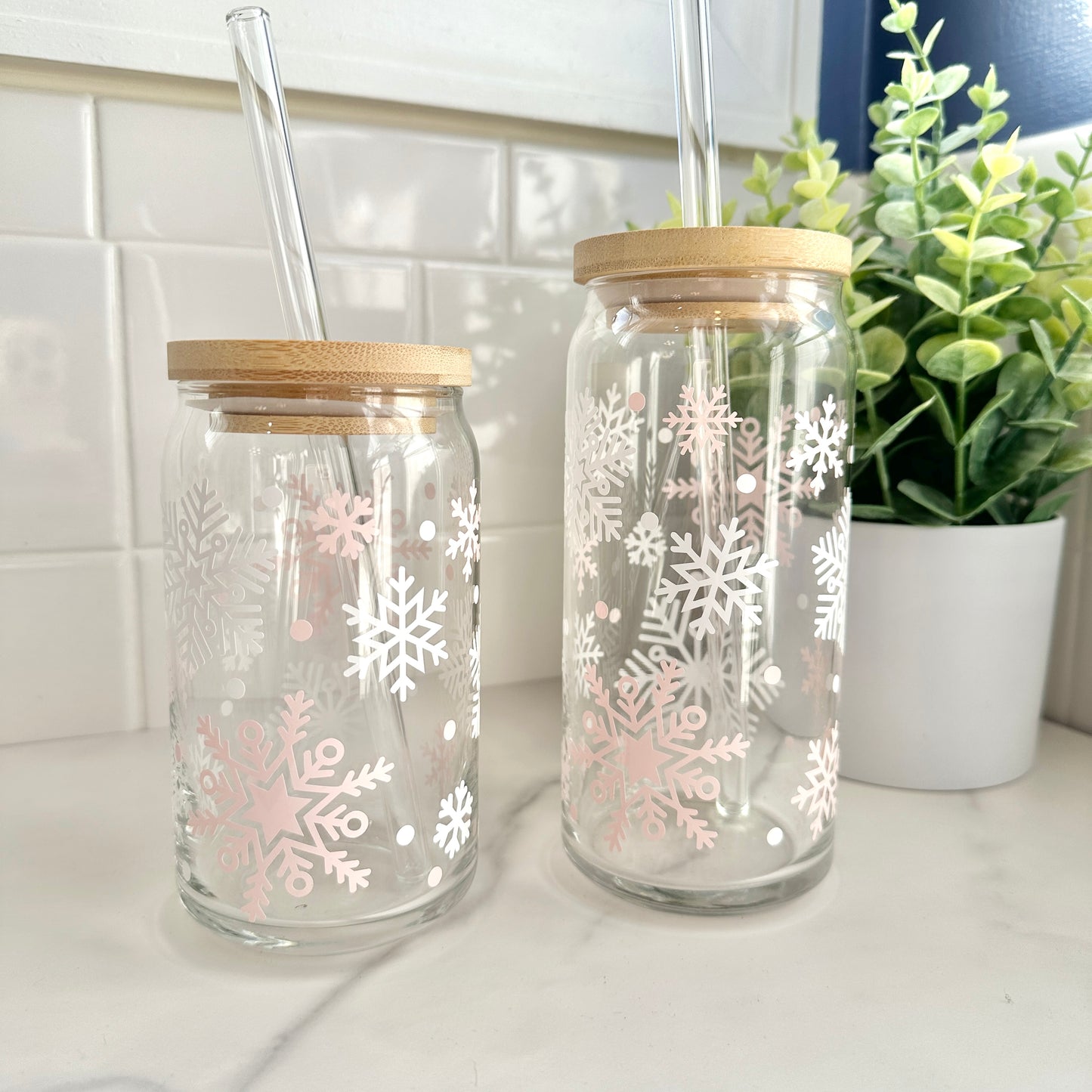 snowflake glass iced coffee glass cups with lids and straws on counter