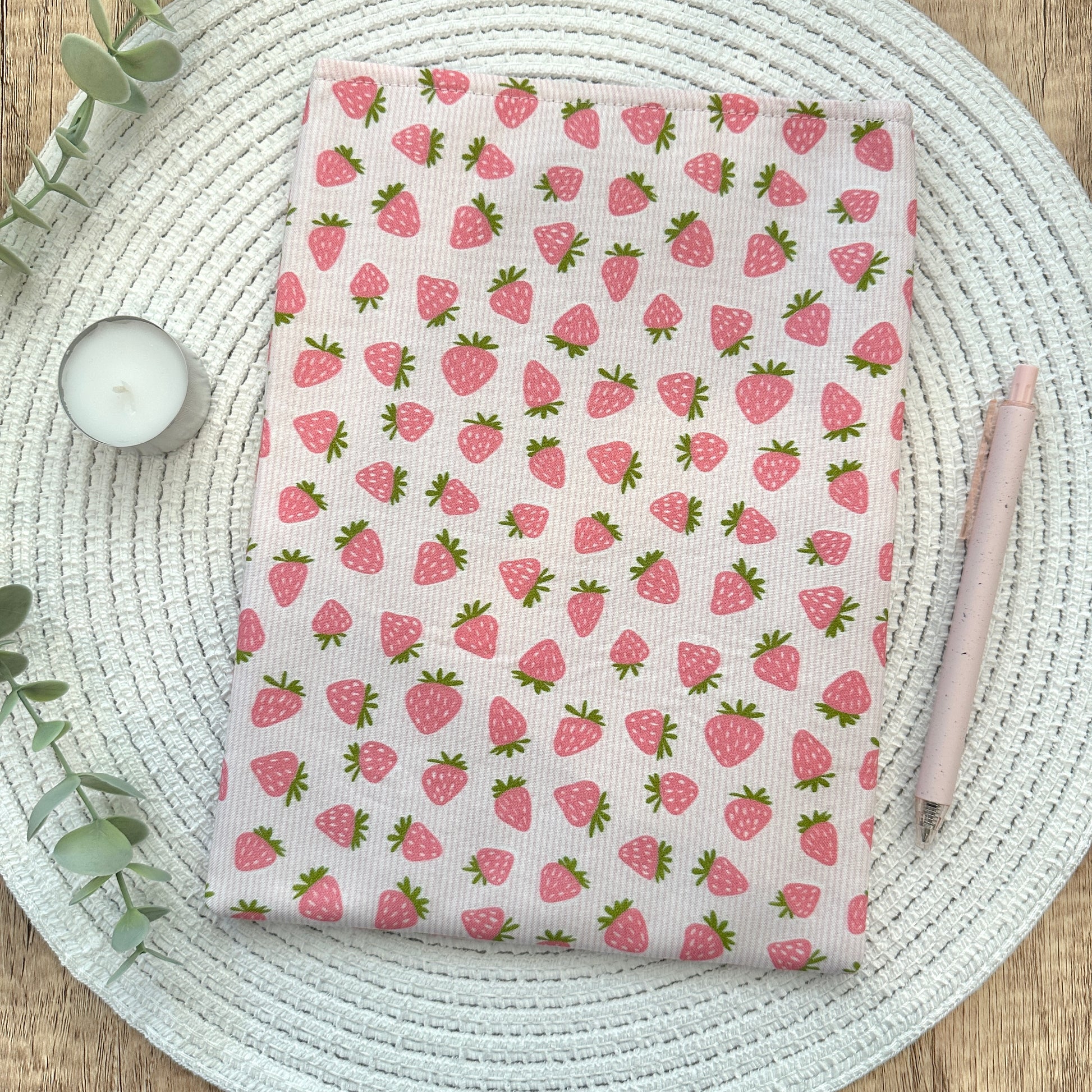 strawberry book sleeve on woven mat