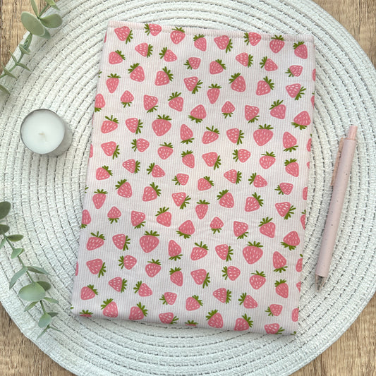 strawberry book sleeve on woven mat