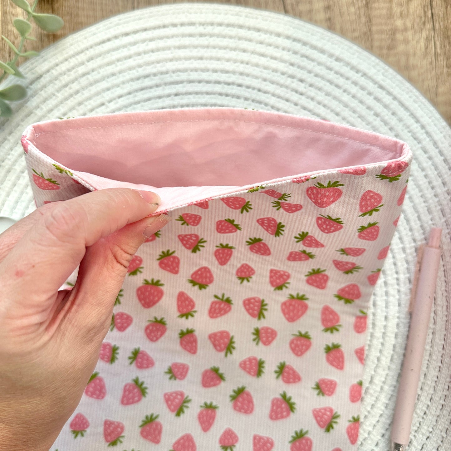 pink lining inside strawberry-patterned book sleeve